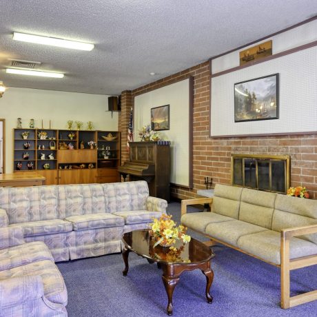 seating area with armchairs and piano